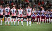 27 June 2025; Players from both teams observe a minute's silence in honour of the late Mary Higgins, mother of former Derry City manager Ruaidhri Higgins, before the SSE Airtricity Men's Premier Division match between Derry City and Drogheda United at The Ryan McBride Brandywell Stadium in Derry. Photo by Shauna Clinton/Sportsfile