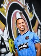 1 July 2025; Bohemians new signing Douglas James-Taylor poses for a portrait in the newly launched Oasis themed Bohemians jersey during his announcement at Dalymount Park in Dublin. Photo by Ramsey Cardy/Sportsfile