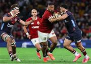 2 July 2025; Bundee Aki of British & Irish Lions is tackled by Hunter Paisami of Queensland Reds during the tour match between Queensland Reds and the British & Irish Lions at Suncorp Stadium in Brisbane, Australia. Photo by Steve Christo/Sportsfile