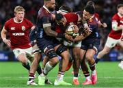 2 July 2025; Bundee Aki of British & Irish Lions is tackled by Hunter Paisami of Queensland Reds during the tour match between Queensland Reds and the British & Irish Lions at Suncorp Stadium in Brisbane, Australia. Photo by Steve Christo/Sportsfile
