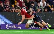 2 July 2025; Huw Jones of British & Irish Lions scores his side's seventh try despite the attempted tackle from Lachie Anderson of Queensland Reds during the tour match between Queensland Reds and the British & Irish Lions at Suncorp Stadium in Brisbane, Australia. Photo by Steve Christo/Sportsfile