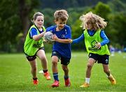 3 July 2025; Theo McLaughlin, centre, with Harry Kenny, right, and Nina Gentles during a Bank of Ireland Leinster Rugby Summer Camp at Stillorgan Rathfarnham RFC in Dublin. Photo by Sam Barnes/Sportsfile