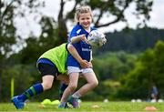 3 July 2025; Isabelle McCarthy is tackled by Donnacha O'Sullivan during a Bank of Ireland Leinster Rugby Summer Camp at Stillorgan Rathfarnham RFC in Dublin. Photo by Sam Barnes/Sportsfile