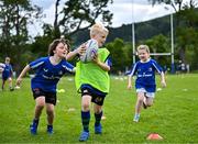 3 July 2025; Donnacha O'Sullivan, centre, with Tadhg Newman, left, and Isabelle McCarthy during a Bank of Ireland Leinster Rugby Summer Camp at Stillorgan Rathfarnham RFC in Dublin. Photo by Sam Barnes/Sportsfile