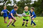 3 July 2025; Finn Baker is tackled by Luke Dolan, left, and Euan King-Elmes during a Bank of Ireland Leinster Rugby Summer Camp at Stillorgan Rathfarnham RFC in Dublin. Photo by Sam Barnes/Sportsfile