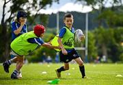 3 July 2025; James Tijs, right, is tackled by Ashie Devitt during a Bank of Ireland Leinster Rugby Summer Camp at Stillorgan Rathfarnham RFC in Dublin. Photo by Sam Barnes/Sportsfile