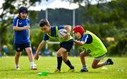 3 July 2025; James Tijs, centre, is tackled by Ashie Devitt during a Bank of Ireland Leinster Rugby Summer Camp at Stillorgan Rathfarnham RFC in Dublin. Photo by Sam Barnes/Sportsfile