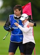 4 July 2025; Leona Maguire of Ireland with her caddie Shane O'Connell after completing her round on the 18th green during day two of the 2025 KPMG Women’s Irish Open Golf Championship at Carton House Golf Club in Maynooth, Kildare. Photo by Seb Daly/Sportsfile