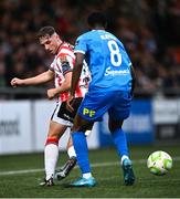 4 July 2025; Gavin Whyte of Derry City in action against James Olayinka of Waterford during the SSE Airtricity Men's Premier Division match between Derry City and Waterford at The Ryan McBride Brandywell Stadium in Derry. Photo by Ramsey Cardy/Sportsfile