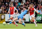 4 July 2025; Dayle Rooney of Bohemians in action against St Patrick's Athletic players, from left, Barry Baggley and Jamie Lennon during the SSE Airtricity Men's Premier Division match between St Patrick's Athletic and Bohemians at Richmond Park in Dublin. Photo by Thomas Flinkow/Sportsfile