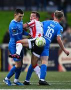 4 July 2025; Adam Frizzell of Derry City in action against Darragh Leahy, left, and Kyle White of Waterford during the SSE Airtricity Men's Premier Division match between Derry City and Waterford at The Ryan McBride Brandywell Stadium in Derry. Photo by Ramsey Cardy/Sportsfile