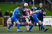 4 July 2025; Adam Frizzell of Derry City in action against Darragh Leahy, left, and Kyle White of Waterford during the SSE Airtricity Men's Premier Division match between Derry City and Waterford at The Ryan McBride Brandywell Stadium in Derry. Photo by Ramsey Cardy/Sportsfile