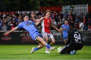4 July 2025; James Clarke of Bohemians in action against St Patrick's Athletic goalkeeper Joseph Anang and Axel Sjoberg, centre, during the SSE Airtricity Men's Premier Division match between St Patrick's Athletic and Bohemians at Richmond Park in Dublin. Photo by Stephen McCarthy/Sportsfile