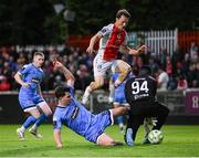 4 July 2025; James Clarke of Bohemians in action against St Patrick's Athletic goalkeeper Joseph Anang and Axel Sjoberg, centre, during the SSE Airtricity Men's Premier Division match between St Patrick's Athletic and Bohemians at Richmond Park in Dublin. Photo by Stephen McCarthy/Sportsfile