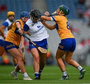 5 July 2025; Abby Flynn of Waterford is tackled by /Niamh Mulqueen, 8, and Danielle Griffin of Clare during the Glen Dimplex Senior All-Ireland Camogie Championship quarter-final match between Clare and Waterford at Croke Park in Dublin. Photo by Ray McManus/Sportsfile
