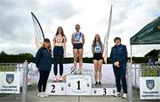 5 July 2025; Athletics Ireland President Bríd Golden, left, with U20 Women's long jump medallists, Riona Doherty of Finn Valley AC, Donegal, gold, centre,  Aine Frawley of St Marys AC, Limerick, silver, left, and Katie Deverell of Tullamore Harriers AC, Offaly, bronze, right,  during the 123.ie National U20 & U23 Championships at Tullamore Harriers Athletics Club in Tullamore, Offaly. Photo by Sam Barnes/Sportsfile