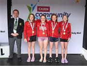 5 July 2025; President of Cairn Community Games Gerry McGuinness with members of the Cork under-13 relay team, from Douglas, from left, Una Casey, Mila Devitt, Lauren Jankowska and Eimear Burke during day one of the Cairn Community Games National Swimming, Quiz, Chess, Draughts and Gymnastics Finals 2025 at The Watershed in Kilkenny. Photo by Matt Browne/Sportsfile