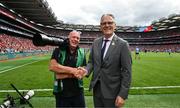 5 July 2025; Irish Exminer photographer Eddie O'Hare, who retired after today's game having served the paper for more than 47 years, is photographed with the Uachtarán Chumann Lúthchleas Gael Jarlath Burns before the GAA Hurling All-Ireland Senior Championship semi-final match between Cork and Dublin at Croke Park in Dublin. Photo by Ray McManus/Sportsfile