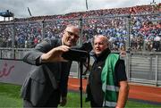 5 July 2025; Irish Exminer photographer Eddie O'Hare, who retired after today's game having served the paper for more than 47 years, is photographed with the Uachtarán Chumann Lúthchleas Gael Jarlath Burns before the GAA Hurling All-Ireland Senior Championship semi-final match between Cork and Dublin at Croke Park in Dublin. Photo by Ray McManus/Sportsfile
