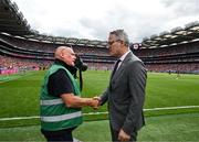5 July 2025; Irish Exminer photographer Eddie O'Hare, who retired after today's game having served the paper for more than 47 years, is photographed with the Uachtarán Chumann Lúthchleas Gael Jarlath Burns before the GAA Hurling All-Ireland Senior Championship semi-final match between Cork and Dublin at Croke Park in Dublin. Photo by Ray McManus/Sportsfile