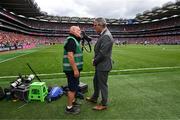 5 July 2025; Irish Exminer photographer Eddie O'Hare, who retired after today's game having served the paper for more than 47 years, is photographed with the Uachtarán Chumann Lúthchleas Gael Jarlath Burns before the GAA Hurling All-Ireland Senior Championship semi-final match between Cork and Dublin at Croke Park in Dublin. Photo by Ray McManus/Sportsfile