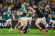 5 July 2025; Jamie Osborne of Ireland is tackled by Luka Ivanishvili and Beka Saghinadze of Georgia during the International Rugby Test match between Georgia and Ireland at at Mikheil Meskhi Stadium in Tbilisi, Georgia. Photo by Brendan Moran/Sportsfile