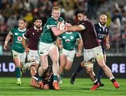 5 July 2025; Jamie Osborne of Ireland is tackled by Luka Ivanishvili and Beka Saghinadze of Georgia during the International Rugby Test match between Georgia and Ireland at at Mikheil Meskhi Stadium in Tbilisi, Georgia. Photo by Brendan Moran/Sportsfile