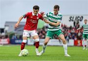 5 July 2025; Ryan O'Kane of Sligo Rovers in action against Matt Healy of Shamrock Rovers during the SSE Airtricity Men's Premier Division match between Sligo Rovers and Shamrock Rovers at The Showgrounds in Sligo. Photo by Thomas Flinkow/Sportsfile