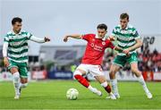 5 July 2025; Ryan O'Kane of Sligo Rovers in action against Matt Healy, right, and Danny Mandroiu of Shamrock Rovers during the SSE Airtricity Men's Premier Division match between Sligo Rovers and Shamrock Rovers at The Showgrounds in Sligo. Photo by Thomas Flinkow/Sportsfile