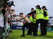 5 July 2025; A Shamrock Rovers supporter is restrained by security during the SSE Airtricity Men's Premier Division match between Sligo Rovers and Shamrock Rovers at The Showgrounds in Sligo. Photo by Thomas Flinkow/Sportsfile