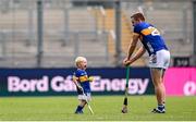 6 July 2025; Noel McGrath of Tipperary and his son Sam, age 2, in an empty stadium after the GAA Hurling All-Ireland Senior Championship semi-final match between Kilkenny and Tipperary at Croke Park in Dublin. Photo by Ramsey Cardy/Sportsfile