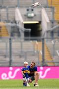 6 July 2025; Noel McGrath of Tipperary and his son Sam, age 2, in an empty stadium after the GAA Hurling All-Ireland Senior Championship semi-final match between Kilkenny and Tipperary at Croke Park in Dublin. Photo by Ramsey Cardy/Sportsfile