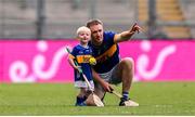6 July 2025; Noel McGrath of Tipperary and his son Sam, age 2, in an empty stadium after the GAA Hurling All-Ireland Senior Championship semi-final match between Kilkenny and Tipperary at Croke Park in Dublin. Photo by Ramsey Cardy/Sportsfile