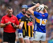 6 July 2025; Darragh McCarthy of Tipperary is comforted by Mikey Butler of Kilkenny, right, as refereee James Owens prepares to show him red card, a second yellow, during the GAA Hurling All-Ireland Senior Championship semi-final match between Kilkenny and Tipperary at Croke Park in Dublin. Photo by Ray McManus/Sportsfile