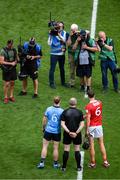 5 July 2025; Referee Johnny Murphy stands with Dublin captian Conor Burke and Cork captain Robert Downey before the GAA Hurling All-Ireland Senior Championship semi-final match between Cork and Dublin at Croke Park in Dublin. Photo by Stephen McCarthy/Sportsfile