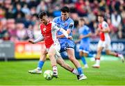 4 July 2025; Jay McClelland of St Patrick's Athletic is tackled by James Clarke of Bohemians during the SSE Airtricity Men's Premier Division match between St Patrick's Athletic and Bohemians at Richmond Park in Dublin. Photo by Stephen McCarthy/Sportsfile