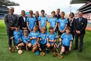 5 July 2025; The Dublin team pose for a group photo with Uachtarán Chumann Lúthchleas Gael Jarlath Burns, Uachtarán of the Camogie Association, Brian Molloy, Head of the Hurling Development Committee, Terry Reilly, GAA National Head of Hurling William Maher, Anne Horan, President, INTO, and Gary Farrell, President, Cumann na mBunscol with players, back row, left to right, Simon McDonagh, St Aidan’s S.N.S, Brookfield, Tallaght, Dublin, TJ Loughlin, St Joseph’s Killucan, Westmeath, Donnacha Devlin, St Peter’s N.S, Dromiskin, Louth, James Gahan, Blackwater N.S, Enniscorthy, Wexford, and Seán O’Connor Rathangan N.S, Duncormick, Wexford, front row, Harry Doyle, The Downs N.S, The Downs, Westmeath, Jack Carroll, Kildalkey N.S, Kildalkey, Meath, Ruadhán Carter, St Kevin’s N.S, Philipstown, Dunleer, Louth, Rhys Curtin, Scoil Thomáis, Laurel Lodge, Castleknock, Dublin, and Fionn Owens, Kilskyre N.S, Kilskyre, Kells, Meath, before the GAA INTO Cumann na mBunscol Respect Exhibition Go Games at the GAA Hurling All-Ireland Senior Championship semi-final match between Cork and Dublin at Croke Park in Dublin. Photo by Ray McManus/Sportsfile