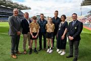 5 July 2025; The referees Darragh Burke, Lackagh N.S, Turloughmore, Galway and Chloe Carrol, Ardrahan N.S, Ardrahan, Galway, pose for a group photo with Uachtarán Chumann Lúthchleas Gael Jarlath Burns, Uachtarán of the Camogie Association, Brian Molloy, Terry Reilly, Head of the Hurling Development Committee,  William Maher, GAA National Head of Hurling, Anne Horan, President, INTO, and Gary Farrell, President, Cumann na mBunscol before the GAA INTO Cumann na mBunscol Respect Exhibition Go Games at the GAA Hurling All-Ireland Senior Championship semi-final match between Cork and Dublin at Croke Park in Dublin. Photo by Ray McManus/Sportsfile