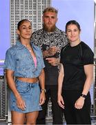 8 July 2025; Katie Taylor, right, and Amanda Serrano square-off on the staircase, with Jake Paul, co-Founder of Most Valuable Promotions, during a lighting up of the Empire State Building, in New York, USA, to kick off Taylor v Serrano 3 fight week ahead of their undisputed super lightweight championship fight that will take place at Madison Square Garden in New York on Friday, 11th July. Additionally, in honor of the historic trilogy fight, the Empire State Building will shine its world-famous tower lights in the colors of Taylor’s and Serrano’s homelands – green, white and orange to represent the Irish flag and blue, white and red to represent the Puerto Rican flag – on fight night. Photo by Stephen McCarthy/Sportsfile