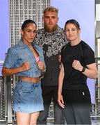 8 July 2025; Katie Taylor, right, and Amanda Serrano square-off on the staircase, with Jake Paul, co-Founder of Most Valuable Promotions, during a lighting up of the Empire State Building, in New York, USA, to kick off Taylor v Serrano 3 fight week ahead of their undisputed super lightweight championship fight that will take place at Madison Square Garden in New York on Friday, 11th July. Additionally, in honor of the historic trilogy fight, the Empire State Building will shine its world-famous tower lights in the colors of Taylor’s and Serrano’s homelands – green, white and orange to represent the Irish flag and blue, white and red to represent the Puerto Rican flag – on fight night. Photo by Stephen McCarthy/Sportsfile