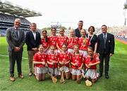 5 July 2025; The Cork team pose for a group photo with Uachtarán Chumann Lúthchleas Gael Jarlath Burns, Uachtarán of the Camogie Association, Brian Molloy, GAA National Head of Hurling William Maher, Anne Horan, President, INTO, and Gary Farrell, President, Cumann na mBunscol with players, back row, left to right, Ayanah Fitzpatrick, GS Liatroma, Cora Droma Ruisc, Leitrim, Annie Hegarty, Kilnamona N.S, Ennis, Clare, Sophie Mooney, Ogonnelloe N.S, Scariff, Clare, Ella Hartnett, Tineteriffe N.S, Cappamore, Limerick, and Emma Maher, Scoil Éanna, Loughrea, Galway, front row, Orla McGrogan, Millquarter P.S, Toome, Antrim, Cuisle Gillen, Bunscoil an tSléibhe Dhuibh, Béal Feirste, Antrim, Kate Ryan, Scoil Fhionain, Kilfinane, Limerick, Aoibheann Burke, Cregmore N.S, Claregalway, Galway, and Shannon Kenny, GS Uileog de Búrca, Clár Chlainne Mhuiris, Mayo, before the GAA INTO Cumann na mBunscol Respect Exhibition Go Games at the GAA Hurling All-Ireland Senior Championship semi-final match between Cork and Dublin at Croke Park in Dublin. Photo by Ray McManus/Sportsfile