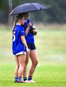 8 July 2025; Cavan's players Sinéad Carolan and Sadhbh Maguire take shelter under an umbrella during the LGFA U17 Player Development Day at Portlaoise GAA club in Portlaoise, Laois. Photo by Stephen Marken/Sportsfile