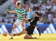 8 July 2025; Mitchell Robertson of Celtic is tackled by Matthew Kiernan of Cork City during the Cork Super Cup match between Cork City and Celtic FC at SuperValu Páirc Uí Chaoimh in Cork. Photo by Thomas Flinkow/Sportsfile