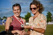 9 July 2025; Megan Keith of Great Britain, left, is presented with her gold medal by Olympian Sonia O'Sullivan after winning the PJ Hegarty Women's 3000m during the Cork City Sports meet at MTU Arena in Cork. Photo by Sam Barnes/Sportsfile