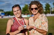 9 July 2025; Megan Keith of Great Britain, left, is presented with her gold medal by Olympian Sonia O'Sullivan after winning the PJ Hegarty Women's 3000m during the Cork City Sports meet at MTU Arena in Cork. Photo by Sam Barnes/Sportsfile