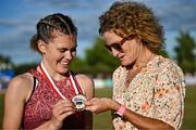 9 July 2025; Megan Keith of Great Britain, left, is presented with her gold medal by Olympian Sonia O'Sullivan after winning the PJ Hegarty Women's 3000m during the Cork City Sports meet at MTU Arena in Cork. Photo by Sam Barnes/Sportsfile