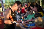 9 July 2025; Marcus Lawler of Ireland signs autographs for supporters after competing in the CETB Men's 200m Race during the Cork City Sports meet at MTU Arena in Cork. Photo by Sam Barnes/Sportsfile