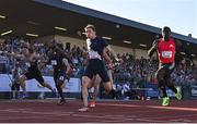 9 July 2025; Coby Hilton of USA, centre, finishes in first place ahead of Israel Olatunde of Ireland, right, who finished second, in the SuperValu Men's 100m Race 2 during the Cork City Sports meet at MTU Arena in Cork. Photo by Sam Barnes/Sportsfile