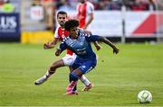10 July 2025; Carlos Duke of FC Hegelmann in action against Zach Elbouzedi of St Patrick's Athletic during the UEFA Conference League First Qualifying Round first leg match between St Patrick's Athletic and FC Hegelmann at Richmond Park in Dublin. Photo by Ben McShane/Sportsfile