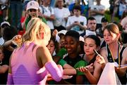 11 July 2025; Sharlene Mawdsley of Ireland signs autographs after winning the Women's 400m final during the 2025 Morton Games at Morton Stadium in Santry, Dublin. Photo by Ramsey Cardy/Sportsfile